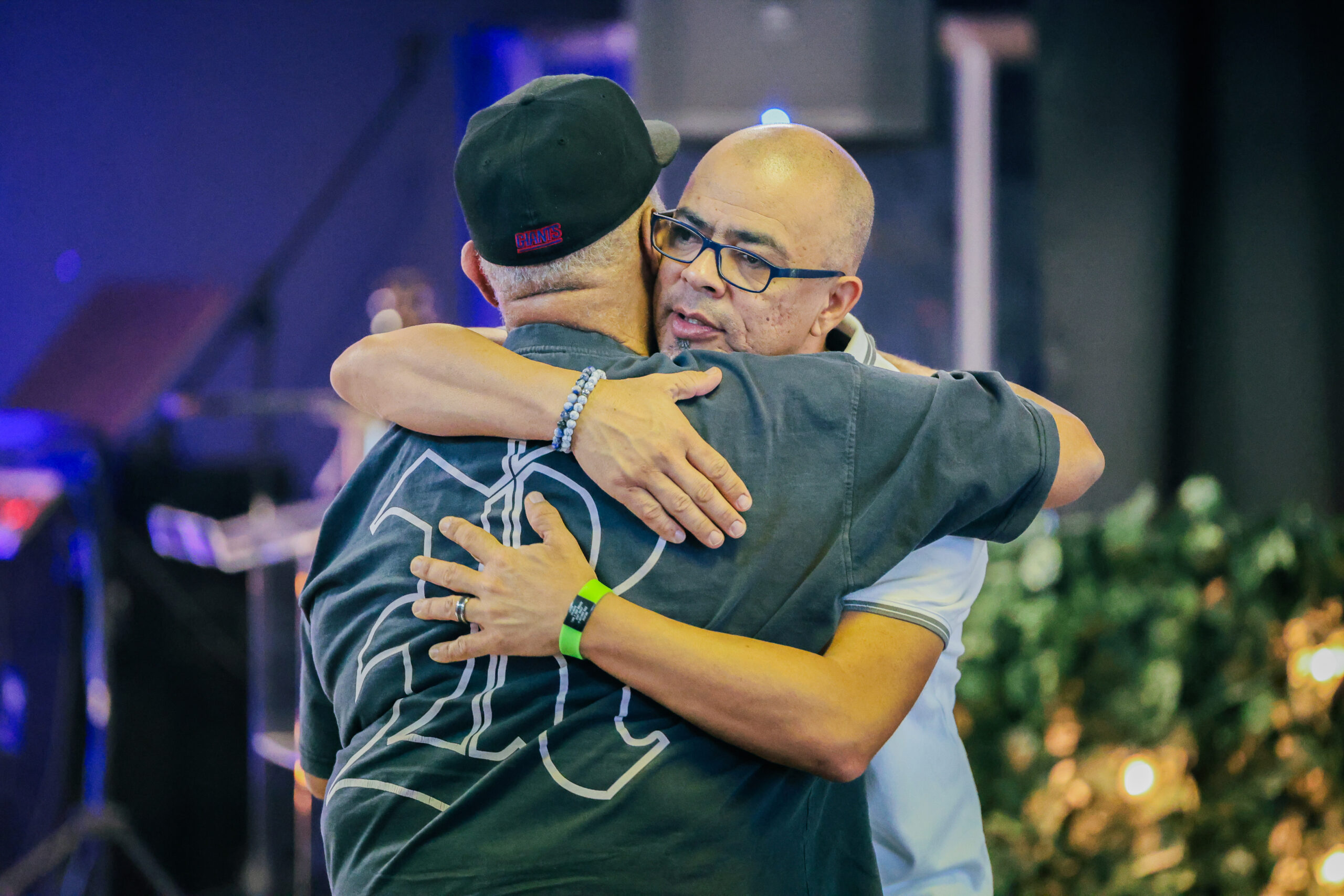 Two men greeting each other with a hug.